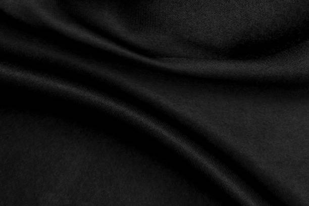 istock Abstract black background. Black silk satin texture background 1398959642