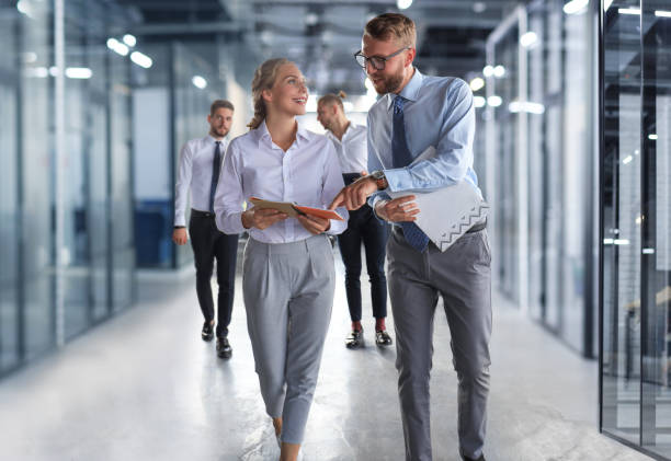 istock Modern business people have a discussion while walking through the office 1398960001