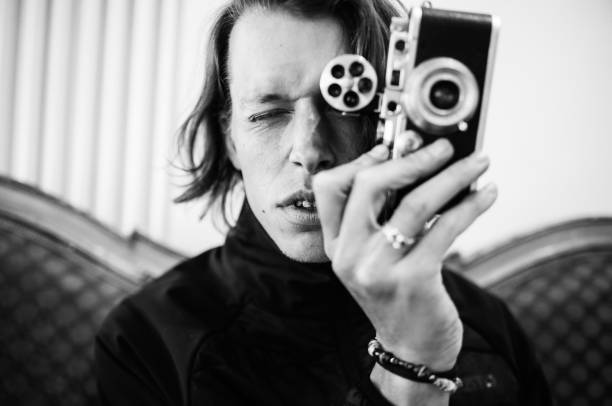 The fashion photographer. Portrait of a successful young Italian fashion photographer. He looks concentrated on his model. Full of passion and professionalism! black and white portrait photographers stock pictures, royalty-free photos & images