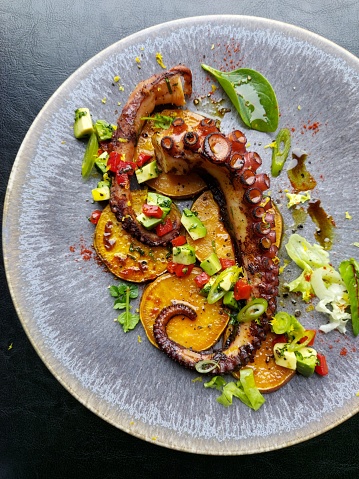 Fresh food grilled octopus delicious cuisine roast sweet potatoes with avocado salsa