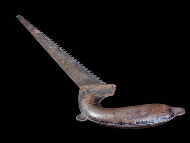 istock Used rusty hand saw isolated on black. 1398961205