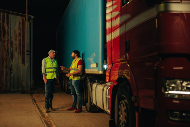 istock Two truck drivers taking a break and hanging 1398961223