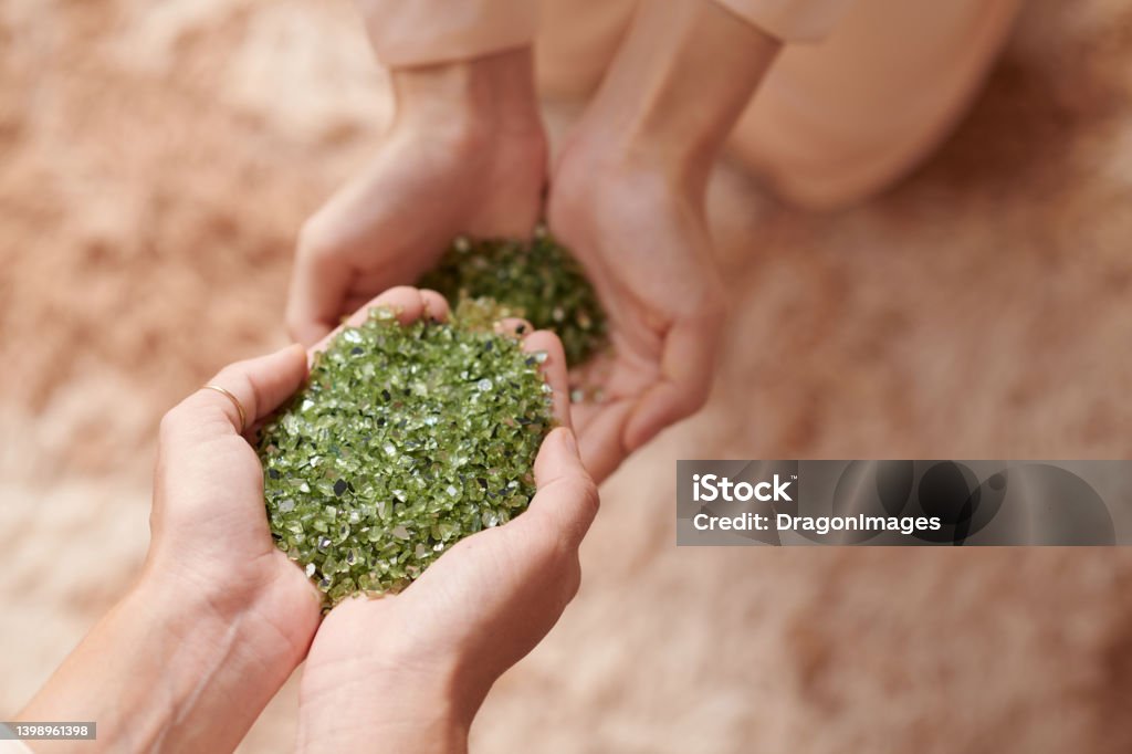 Woman Holding Handful of Nurdle Hands of woman holding handful of nurdle, pre-production microplastic pellets Environmental Conservation Stock Photo