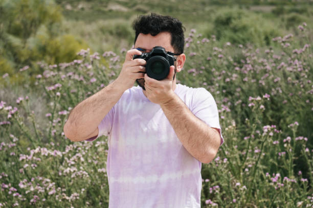 istock Man taking a picture with a DSLR camera 1398961452