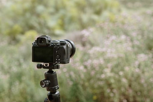 Mirrorless DSLR camera on a tripod with copy space