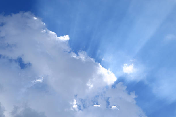 Fluffy clouds with sun on the sky, soft focus. Heavenly clouds background in summer day. Concept of freedom, relaxation, ecology. Copy space. Empty place for message.