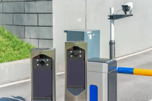 Photo of smart automatic parking lot identification system with barrier arm.