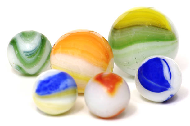 A handful of colorful milky glass toy marbles on a white background.