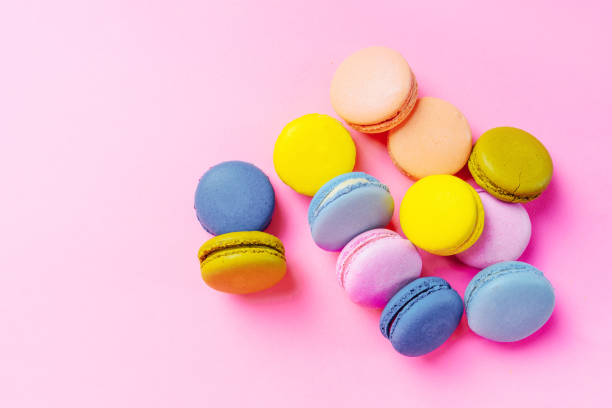 istock French macarons dessert on a pink background, top view 1398964614