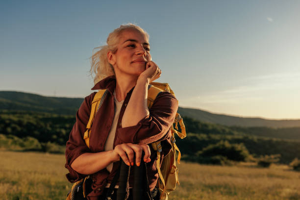 Woman hiking and going camping in nature, taking a rest after long walk