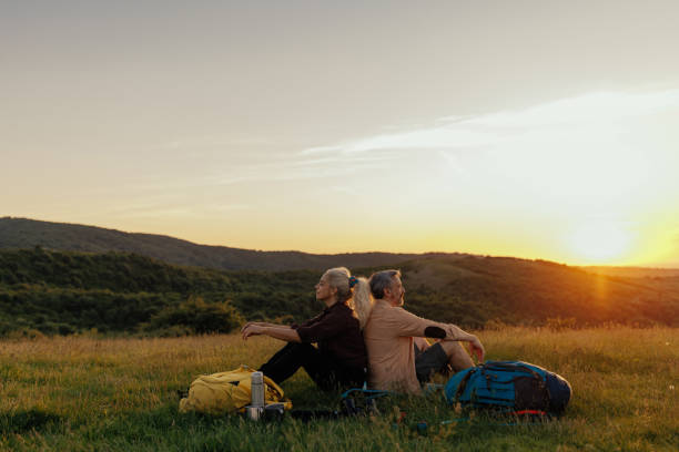 istock Couple of hikers resting on mountain 1398965525