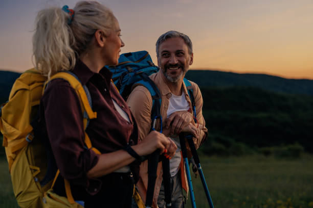 istock Couple walking with hiking poles in nature 1398965547