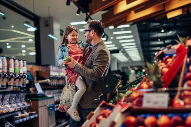 istock Cute single father and his daughter in shopping 1398965612