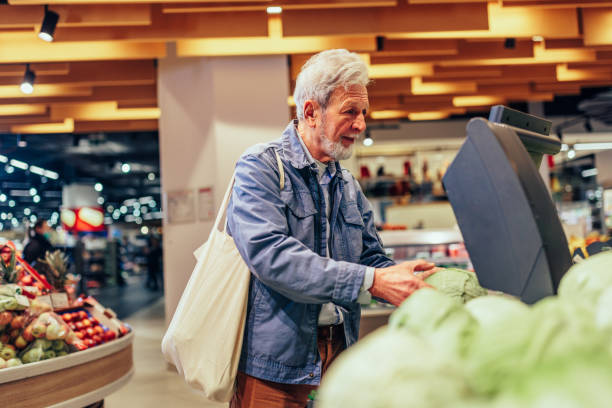 istock Man in supermarket measuring vegetables 1398965630