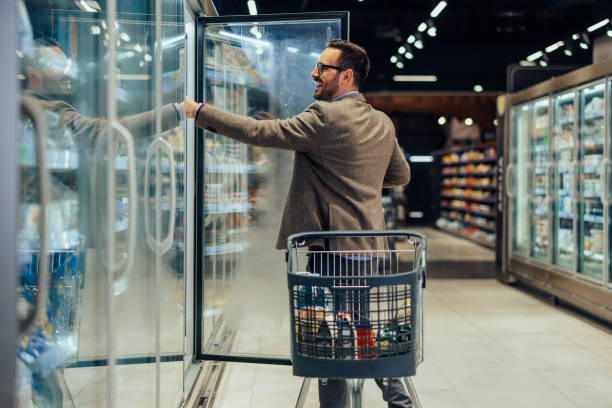 istock Man taking dairy products off the shelf 1398965771