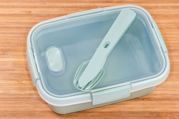 istock Empty food storage container with cutlery set on wooden surface 1398965789