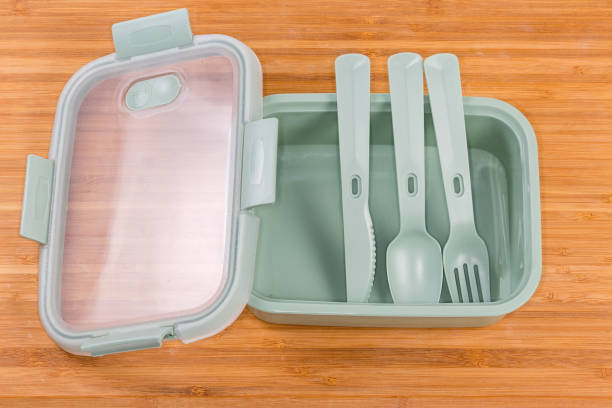 istock Empty food storage container with cutlery set on wooden surface 1398965804
