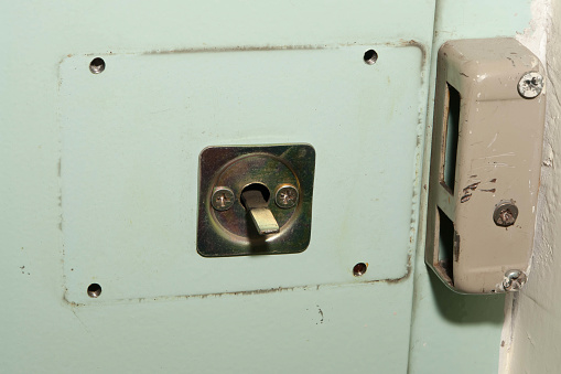 Old locked up padlock on white background