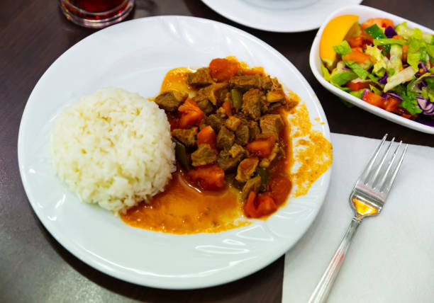 Lamb with stewed vegetables and rice. Turkish dish coban kavurma