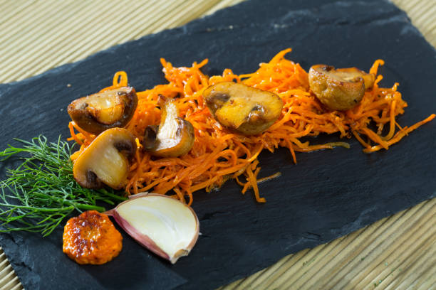 istock Mushrooms freshly fried in oil with carrot 1398970578