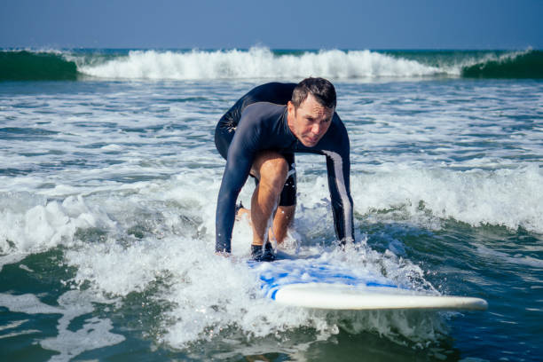 istock surf instructor showing how riding on big waves in Goa India 1398970888