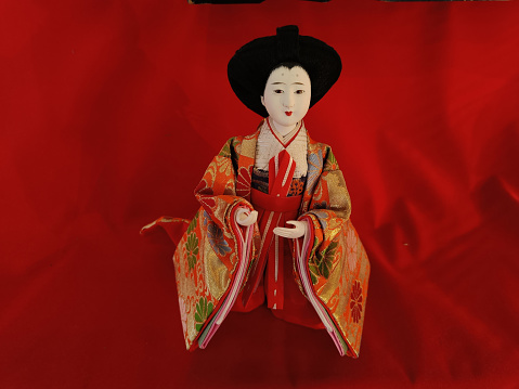pretty japanese doll on a red background