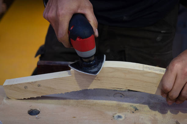 istock Close up carpenter use orbit sander polishes wooden in the workshop. 1398973237