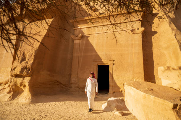 istock Young Middle Eastern man visiting rock-cut tombs in Hegra 1398974779