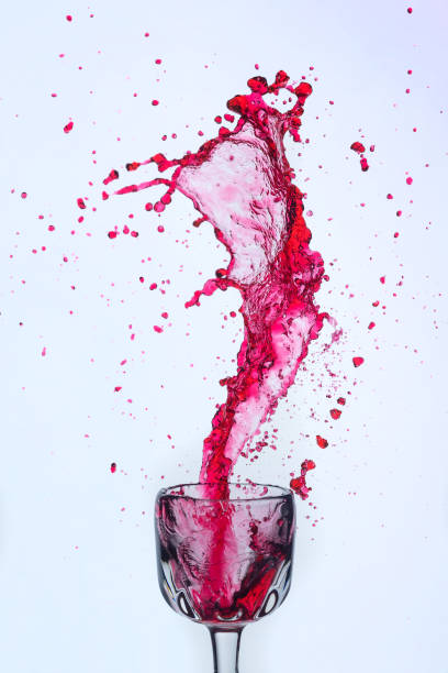 istock A splash of red wine in a glass on a white background. 1398974936