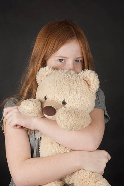 istock young girl is cuddling with a teddybear 139897499