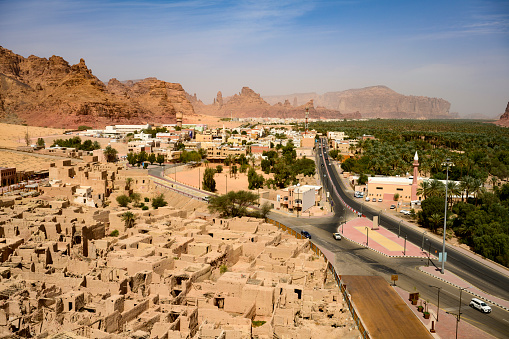 Elevated view over AlUla valley with old town and modern road