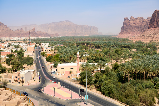 Elevated view of AlUla new town with road and palm grove