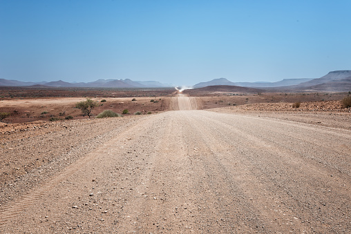 Sandy empty road crossing the namibian desert. Namibia. Africa