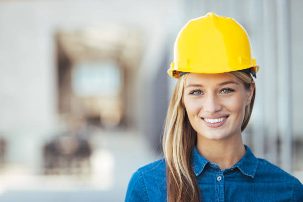 istock Happy female architect at construction site, looking at camera. 1398976365