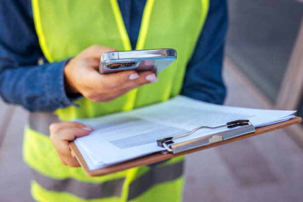 istock Shot of a young businesswoman using her smartphone while on a construction site 1398976407