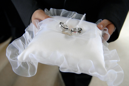 Ringbearer carrying the wedding rings on a pillow.