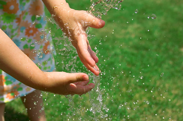 istock Children playing outside with water 139897662