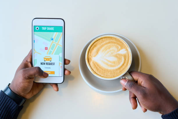 istock Man booking taxi using mobile application on smartphone 1398978947