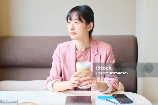 カフェでコーヒーブレイクに座っている女性