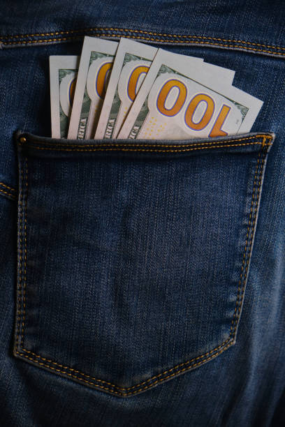 istock Blue jeans pocket with hundred dollars banknotes 1398982321