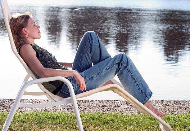 Blonde woman relaxing on a deckchair.
