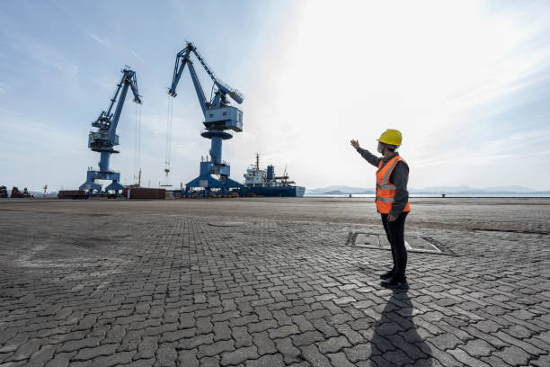 istock An Asian woman worker works at a cargo port. 1398983612