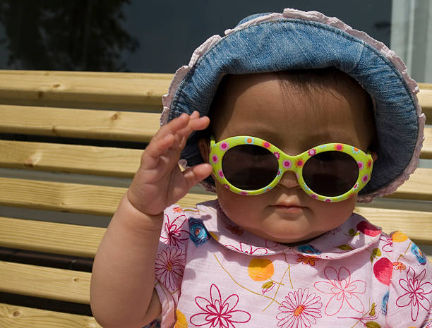 baby girl with sun glasses stock photo