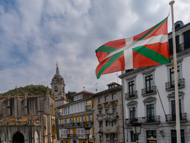 downtown Lekeitio with historic buildings and the Basque Country flag Lekeitio, Spain - 4 May, 2022: downtown Lekeitio with historic buildings and the Basque Country flag comunidad autonoma del pais vasco stock pictures, royalty-free photos & images
