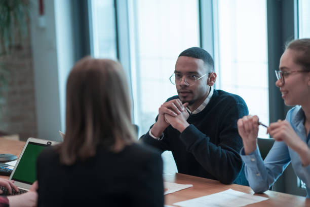 istock Successful team. Group of young multi-ethnic business people working and communicating together in creative office. Selective focus 1398984520