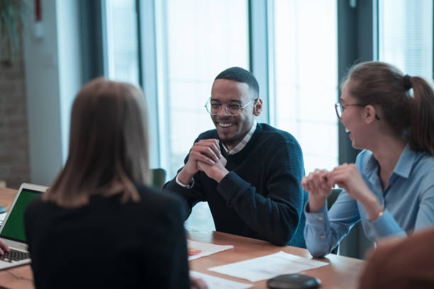 istock Successful team. Group of young multi-ethnic business people working and communicating together in creative office. Selective focus 1398984688