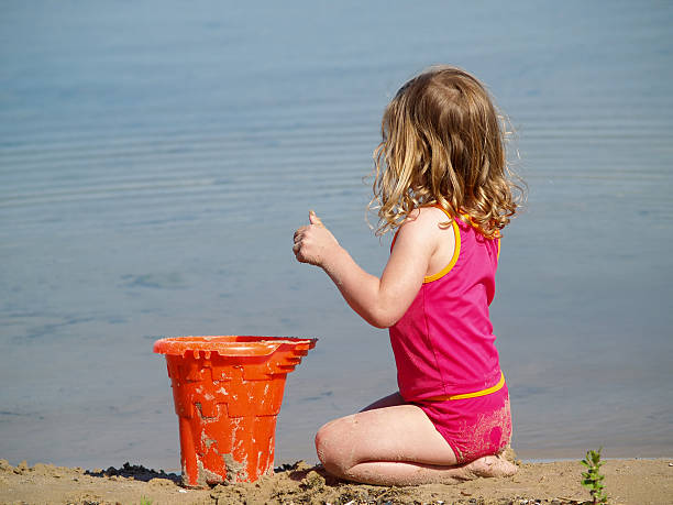 istock girl playing at beach 139898479