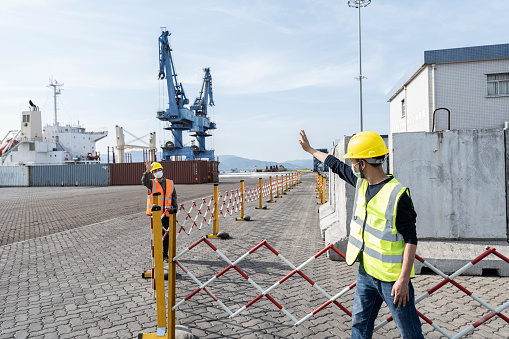 Two port engineers work at a commercial cargo port  in Fujian China Asia.