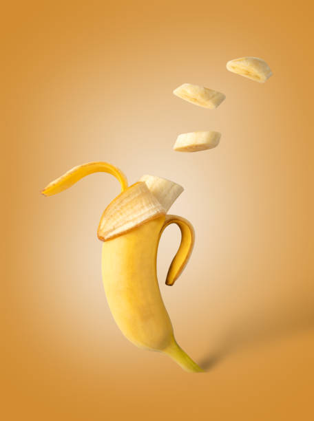 istock Opened and sliced banana on an orange background. 1398985572