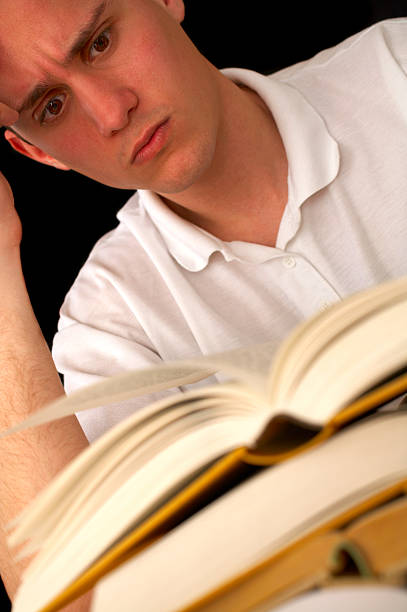 istock Stressed out man with a big stack of books 139898601